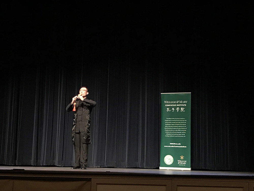 2. Volunteer Teacher Jie Hou performs a piece on the hulusi